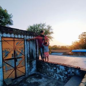 Man standing against built structure against sky