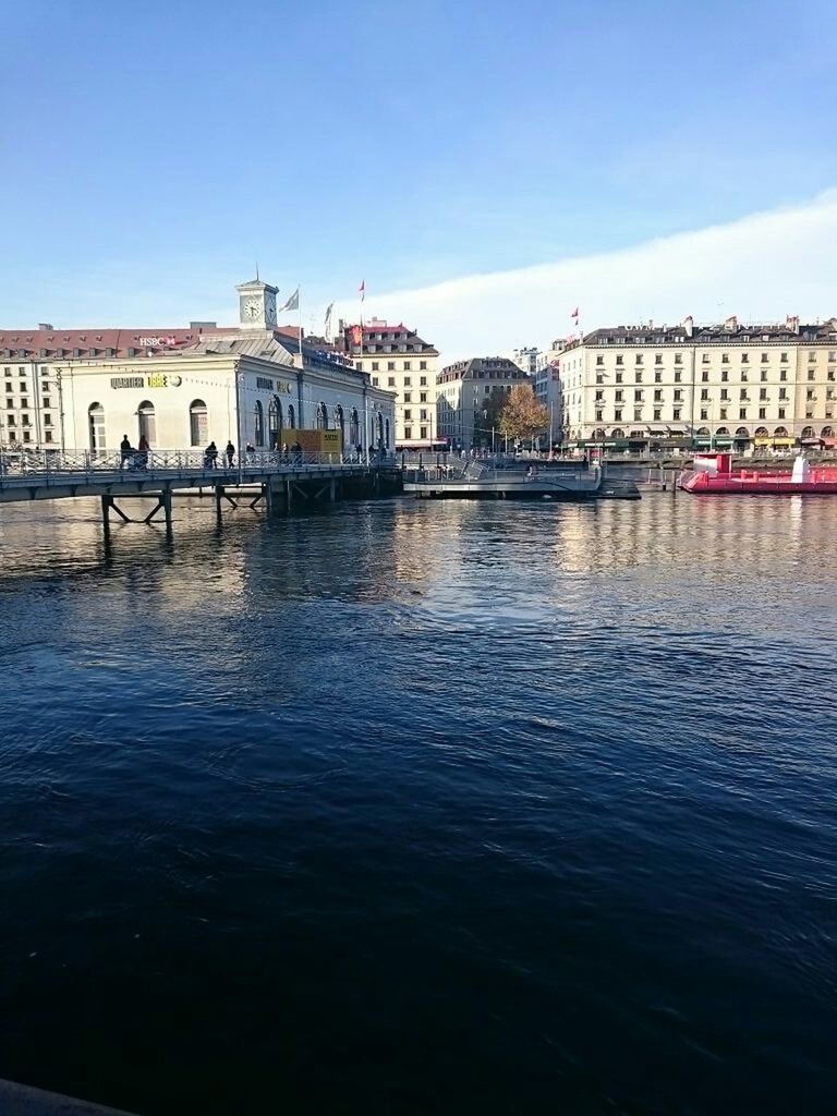 architecture, built structure, building exterior, water, waterfront, city, river, clear sky, blue, rippled, residential building, sky, residential structure, nautical vessel, canal, incidental people, building, day, transportation, outdoors