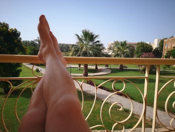 Low section of person relaxing on swimming pool