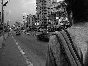 Rear view of man on street in city