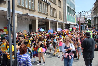 Group of people walking on street in city