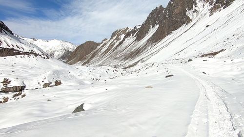 Scenic view of snow covered mountains against sky