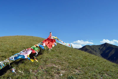 Traditional windmill on field against sky