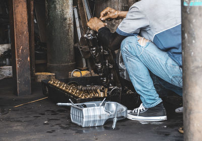 Low section of man working at workshop