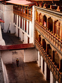 High angle view of man walking by building