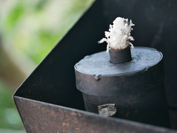 Close-up of candle on metal outdoors