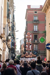 People on street amidst buildings in city