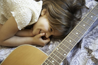 High angle view of boy lying on bed