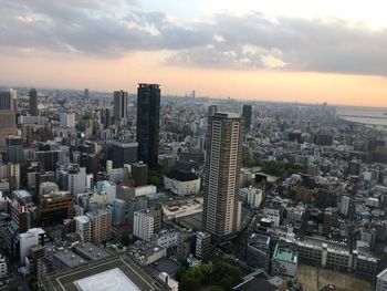 Cityscape against cloudy sky