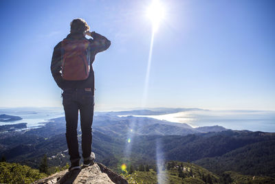 Man standing on mountain road against sky