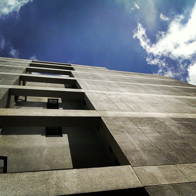 architecture, low angle view, built structure, building exterior, sky, cloud - sky, blue, day, pattern, glass - material, building, cloud, architectural feature, outdoors, no people, modern, sunlight, reflection, city, window