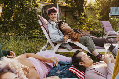 Happy friends of lgbtq community during dinner party in back yard