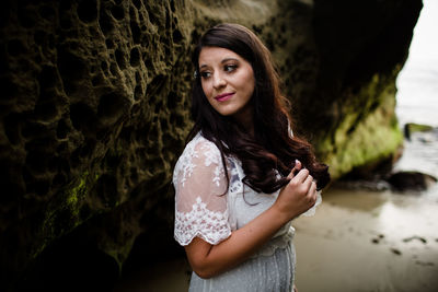 Portrait of a smiling young woman standing outdoors