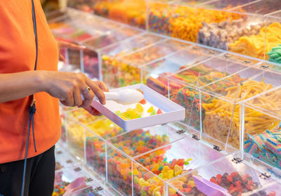 Woman select buying jelly at street food festival.