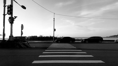 Cars on road against sky