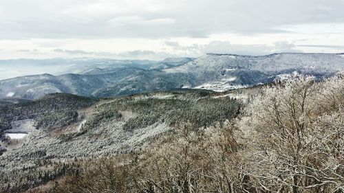 Scenic view of mountains against cloudy sky