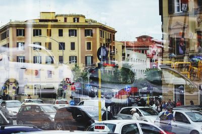 Traffic on city street seen through glass window