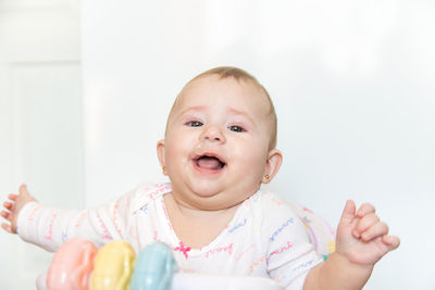 Portrait of baby girl with mucus coming out from nose at home