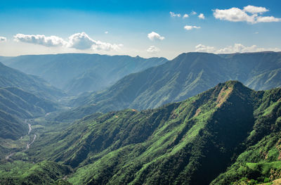 Misty mountain range covered with white mist and amazing blue sky