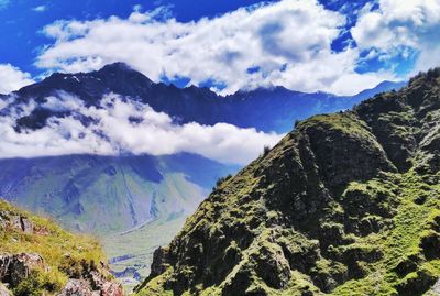 Scenic view of mountains against cloudy sky