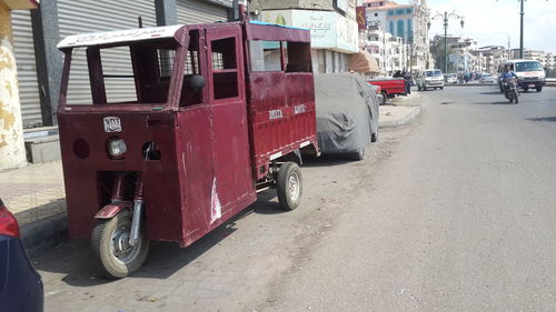 Vehicles on road along buildings