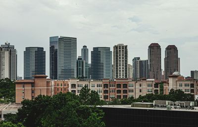 Buildings in city against sky