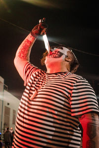 Low angle view of man holding ice cream