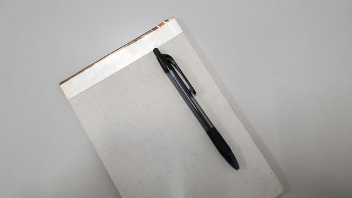 High angle view of pen on table against white background