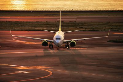 Airplane flying over airport runway