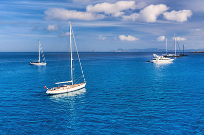 Sailboats on sea against sky