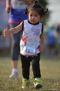 Portrait of cute girl walking in marathon