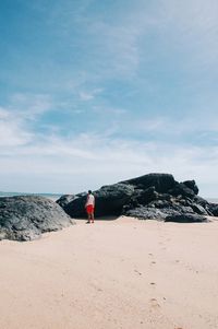 Man standing on beach against sky