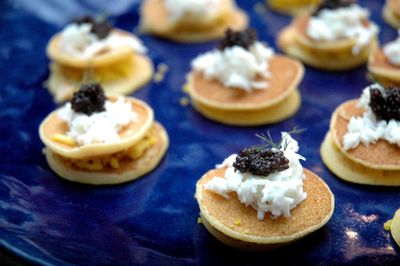 Close-up of caviar on blini on table