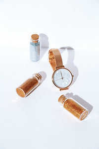 High angle view of bottles on table against white background