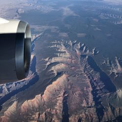 Cropped image of jet engine over landscape