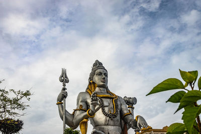 Low angle view of statue against sky