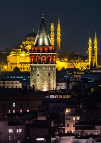 Illuminated suleymaniye mosque and galata tower in city at night