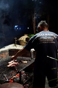 Rear view of man standing at night