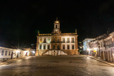 Illuminated building in city at night