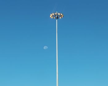 Low angle view of street light against clear blue sky