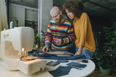 Design professionals working on denim in workshop