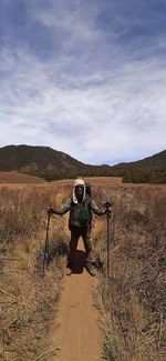 Man standing on field against sky