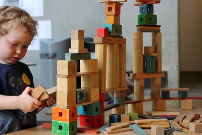 Boy playing with toy blocks at home