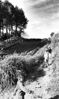 Full length of woman standing on grassy field