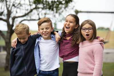 Smiling children looking away