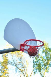 Low angle view of basketball hoop against clear blue sky