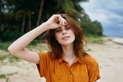 Portrait of smiling young woman at beach