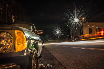 Illuminated city street at night