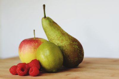 Close-up of red apple on white background