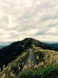 Scenic view of mountains against cloudy sky